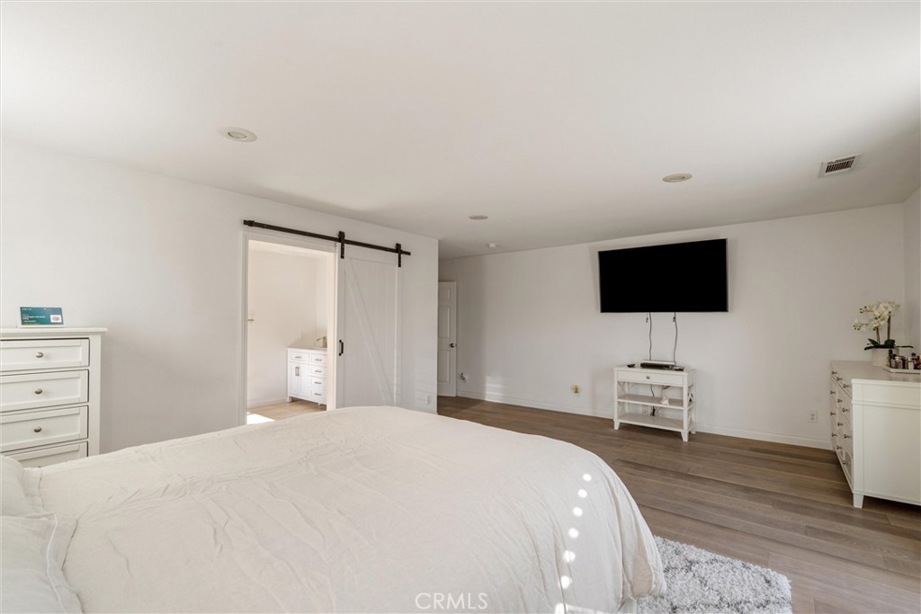 9434 Pico Vista Road Downey, CA 90240 - Photo 27 of 51 a bedroom with a bed and a flat screen tv