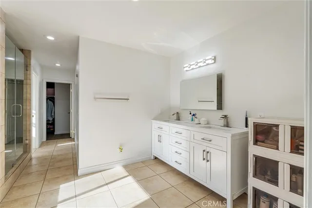 a bathroom with a tub a window and a shower