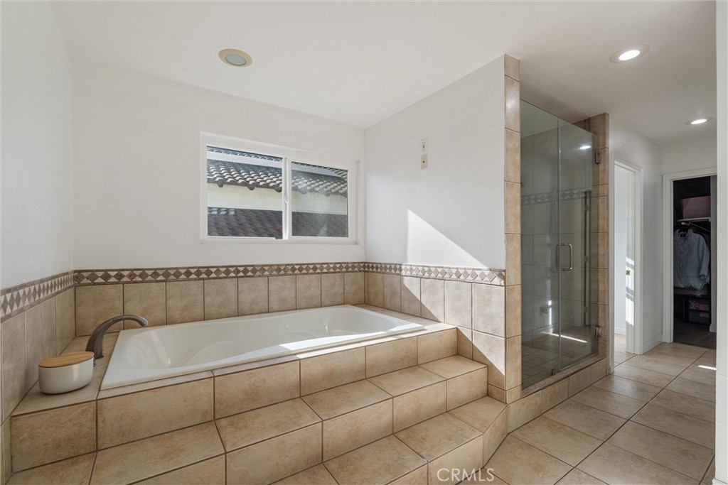 9434 Pico Vista Road Downey, CA 90240 - Photo 29 of 51 a bathroom with a tub a window and a shower