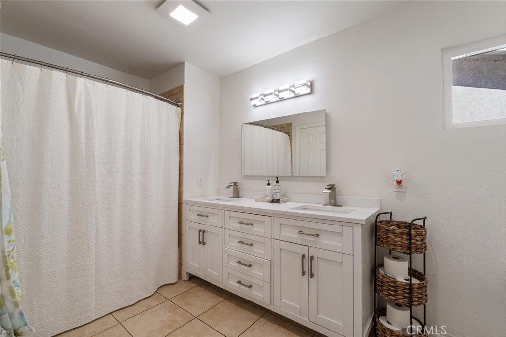 9434 Pico Vista Road Downey, CA 90240 - Photo 33 of 51 a spacious bathroom with a double vanity sink a mirror and a shower