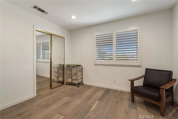 a spacious bedroom with a bed and a flat screen tv