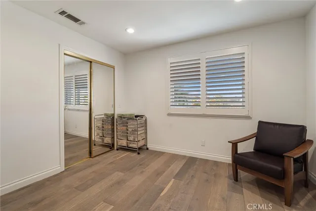 a spacious bedroom with a bed and a flat screen tv