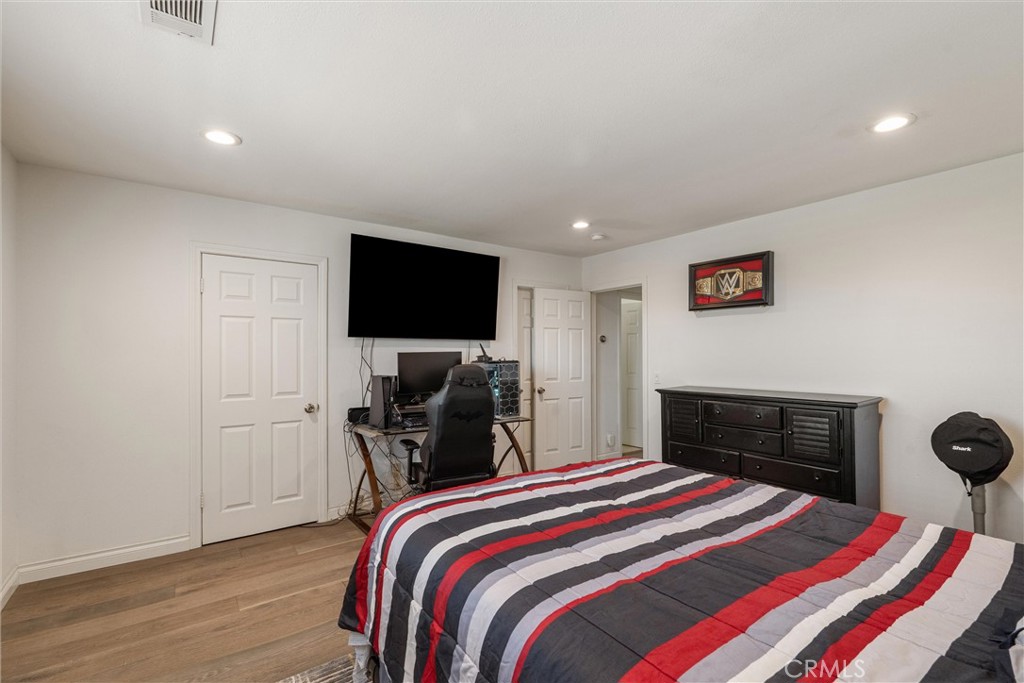 9434 Pico Vista Road Downey, CA 90240 - Photo 36 of 51 a bedroom with a bed and a flat screen tv