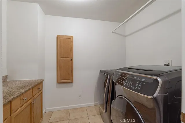 a view of an empty walk in closet with wooden floor
