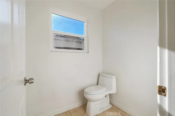 an empty room with wooden floor and closet