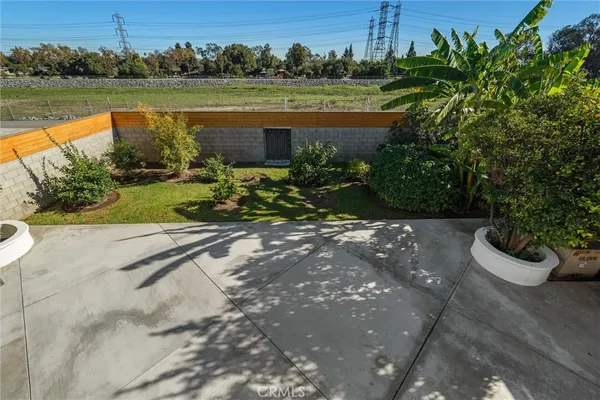a view of a house with a yard and potted plants