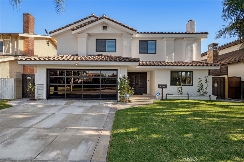 9434 Pico Vista Road Downey, CA 90240 - Photo 5 of 51 a front view of a house with a garden and yard
