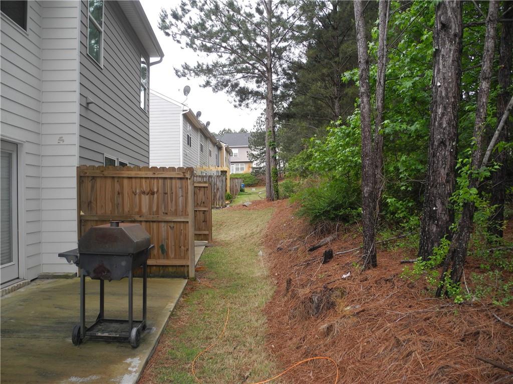 3353 Sable Elm Court Atlanta, GA 30349 - Photo 16 of 18 a backyard of a house with table and chairs