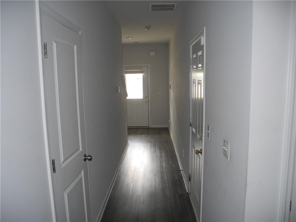 3353 Sable Elm Court Atlanta, GA 30349 - Photo 3 of 18 a view of a hallway with wooden floor and a window