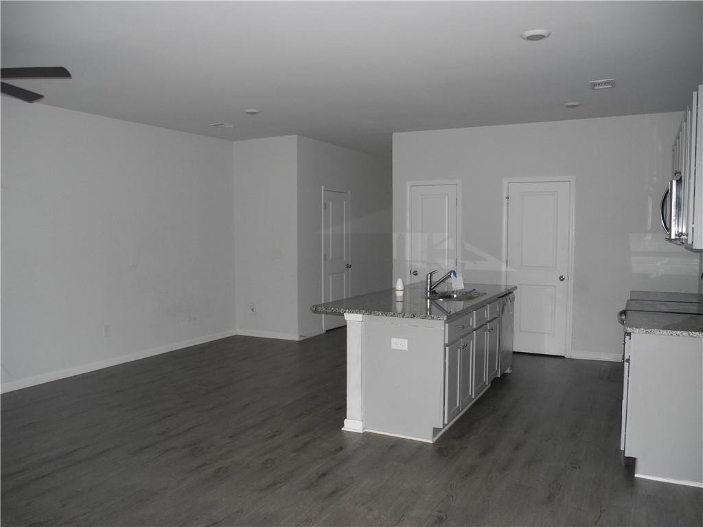3353 Sable Elm Court Atlanta, GA 30349 - Photo 7 of 18 a view of a kitchen with sink and wooden floor