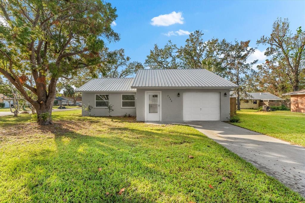 2382 Spring Oaks Court Sarasota, FL 34234 - Photo 1 of 1 a front view of a house with a garden