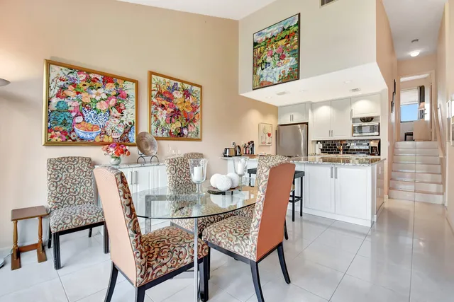 a dining room with furniture and a kitchen view