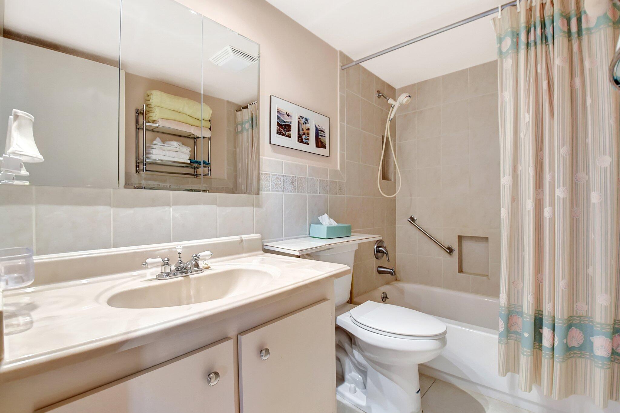 755 Dotterel Road, Unit 1512 Delray Beach, FL 33444 - Photo 23 of 48 a bathroom with a sink toilet and shower