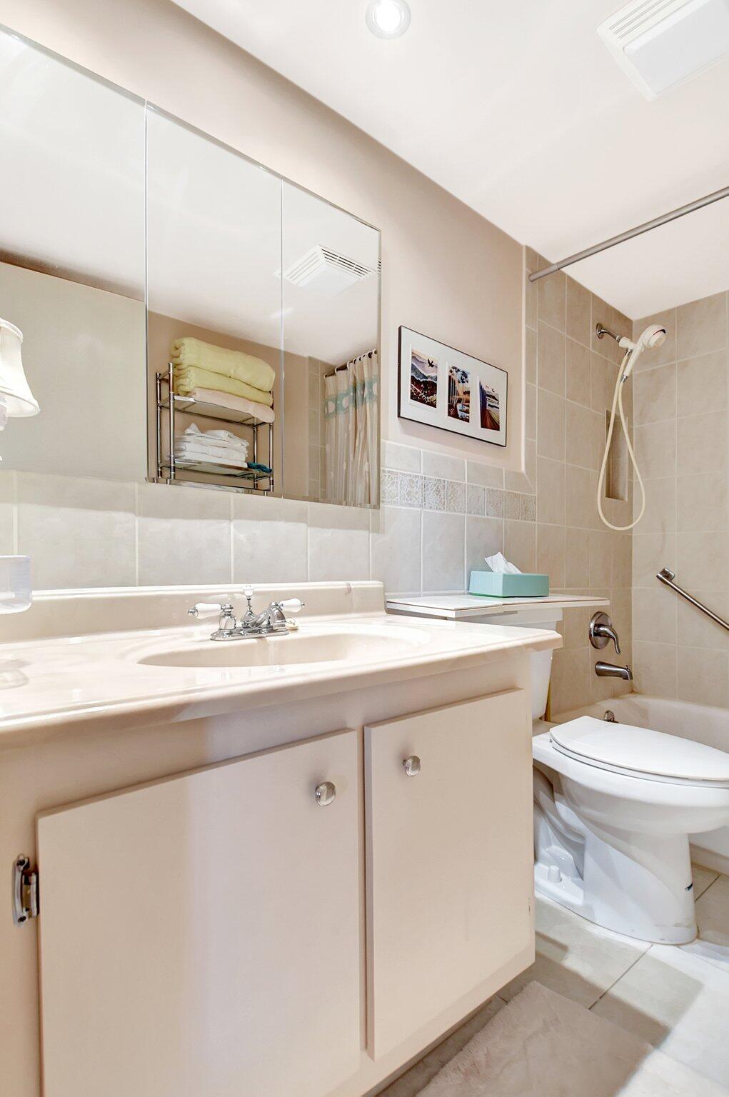 755 Dotterel Road, Unit 1512 Delray Beach, FL 33444 - Photo 24 of 48 a bathroom with a granite countertop sink mirror and toilet