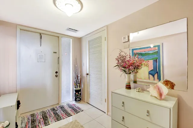 a view of bathroom with a potted plant on the counter shower and a mirror