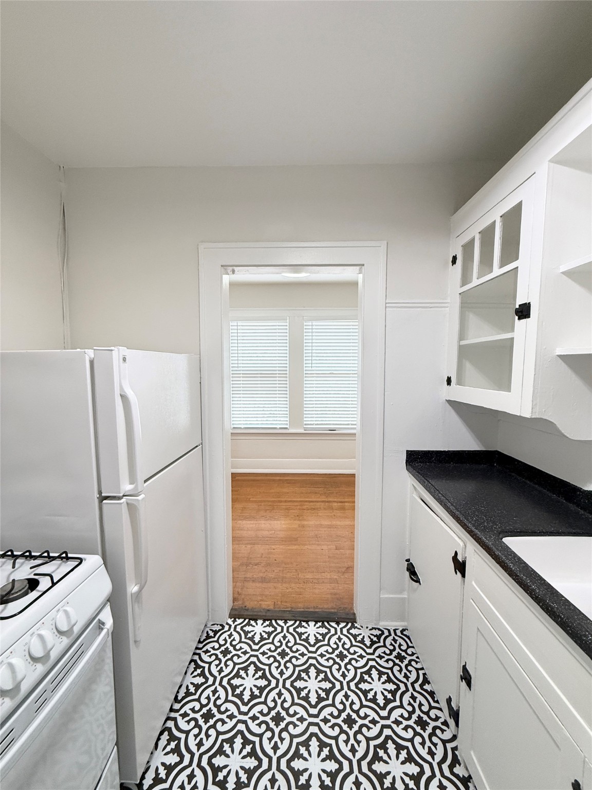 1126 Berthea Street, Unit 16 Houston, TX 77006 - Photo 11 of 16 a kitchen with a refrigerator and cabinets