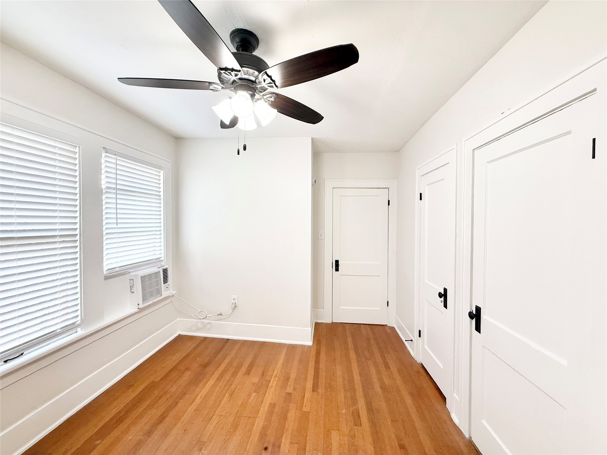 1126 Berthea Street, Unit 16 Houston, TX 77006 - Photo 13 of 16 a view of an empty room with wooden floor and a window