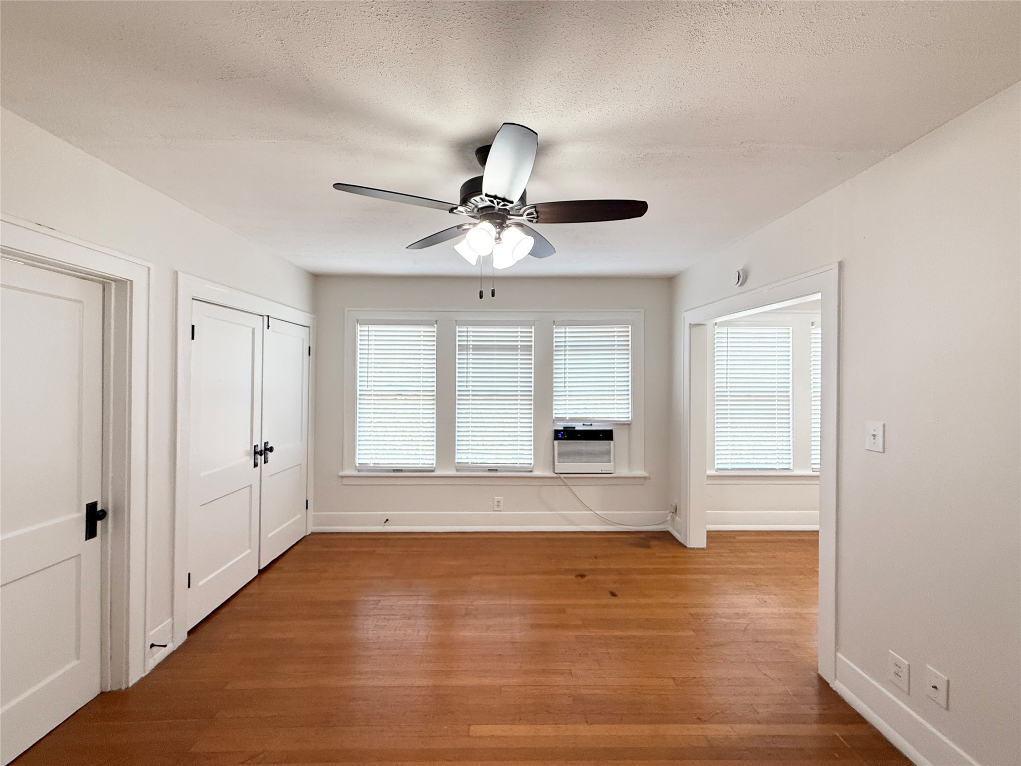 1126 Berthea Street, Unit 16 Houston, TX 77006 - Photo 2 of 16 a view of empty room with wooden floor and fan
