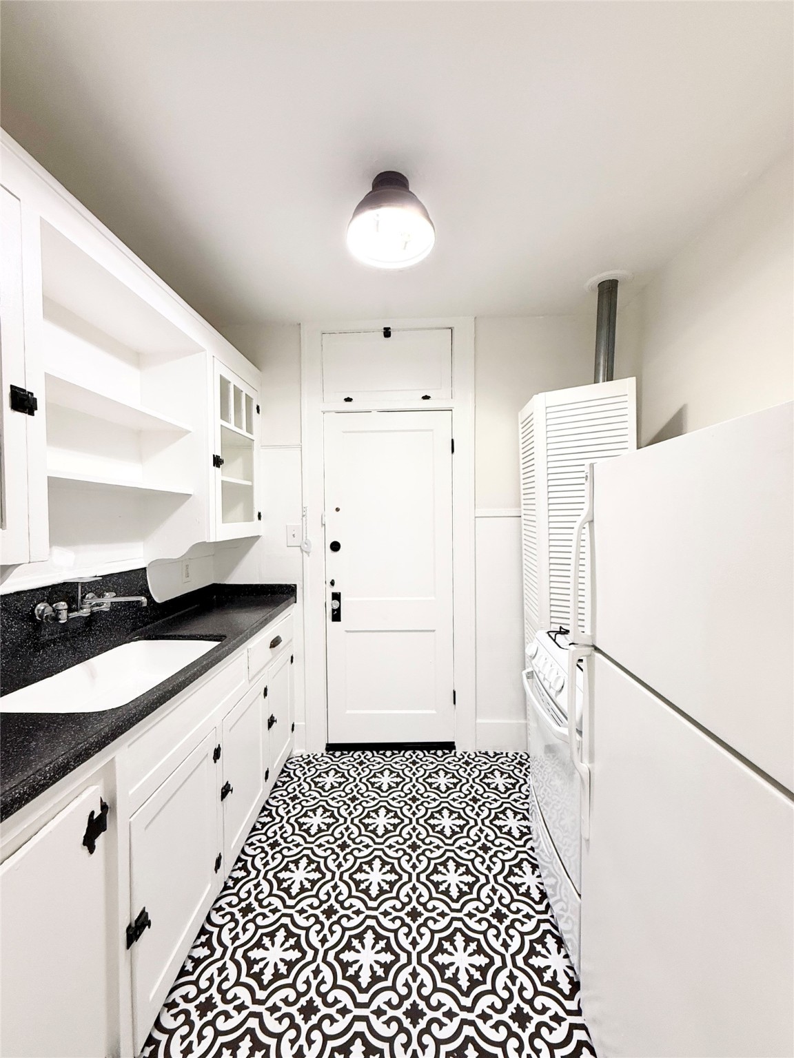 1126 Berthea Street, Unit 16 Houston, TX 77006 - Photo 8 of 16 a bathroom with a sink a toilet a mirror and vanity