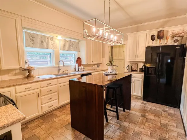 a kitchen with a sink a counter top space and stainless steel appliances