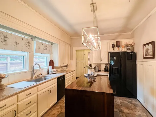 a kitchen with sink and refrigerator