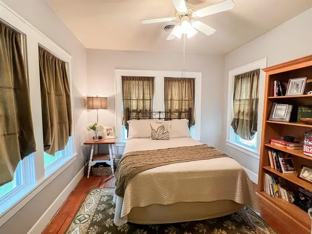 a bathroom with a sink a toilet a mirror and shower