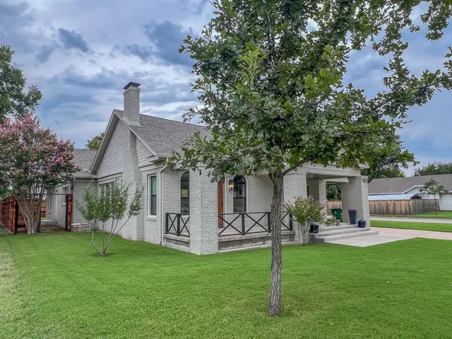 a front view of house with a garden and patio