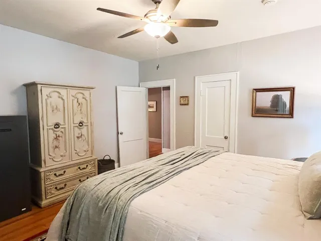 a bedroom with a bed and a chandelier