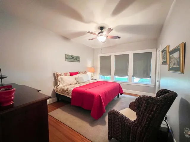 a view of a hallway view with wooden floor and staircase
