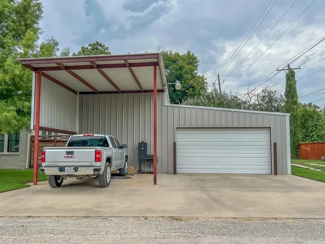 a view of a patio with table and chairs and potted plants