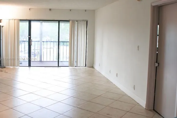 a view of an empty room with a window