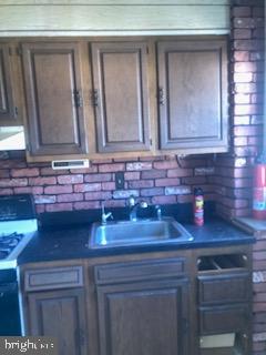 722 Shepherd Street Northwest Washington, DC 20011 - Photo 16 of 25 Rustic kitchen with brick accents.