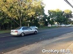 52 Main Road Riverhead, NY 11901 - Photo 9 of 13 a view of street with parked cars