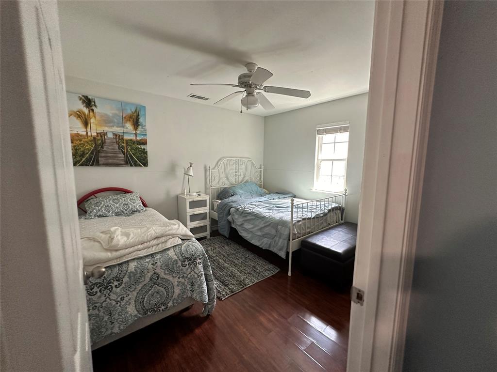 2707 Jim Street Dallas, TX 75212 - Photo 12 of 17 a bedroom with furniture and a chandelier