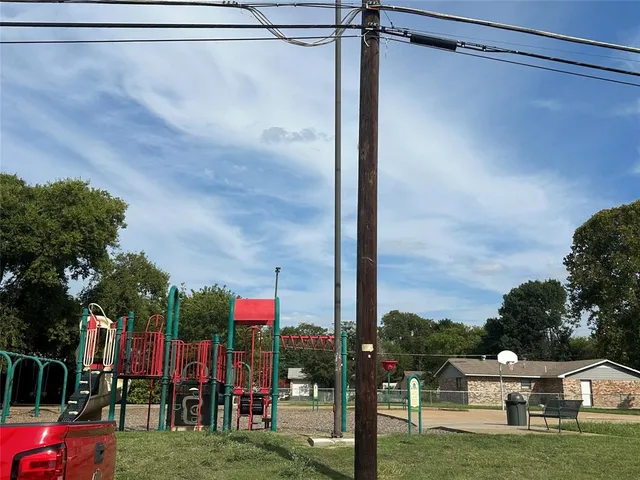 a view of a house with backyard and a slide