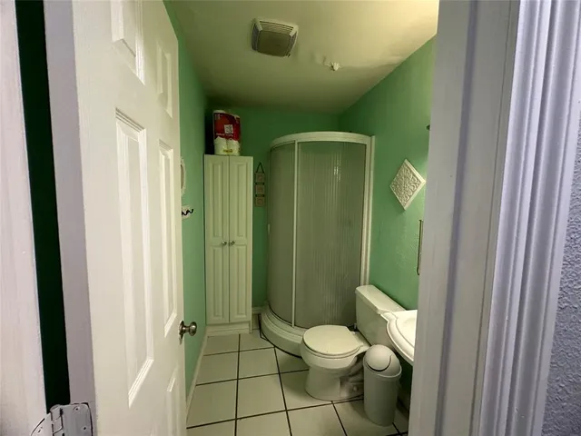 a bathroom with a toilet and a shower