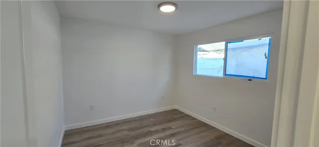 a view of a small space with wooden floor and a window