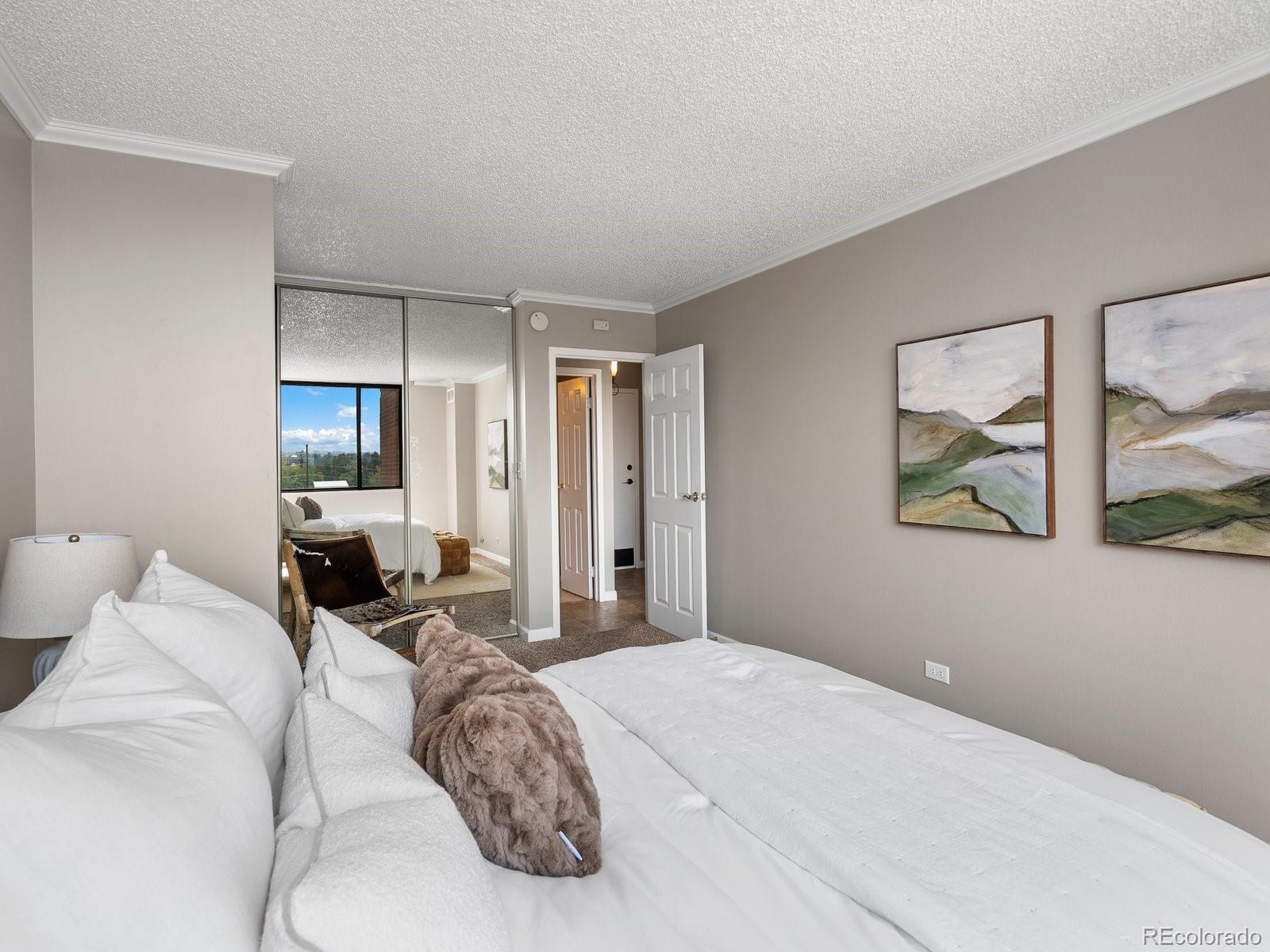 1850 Folsom Street, Unit 402 Boulder, CO 80302 - Photo 12 of 28 a bedroom with a bed and glass wall