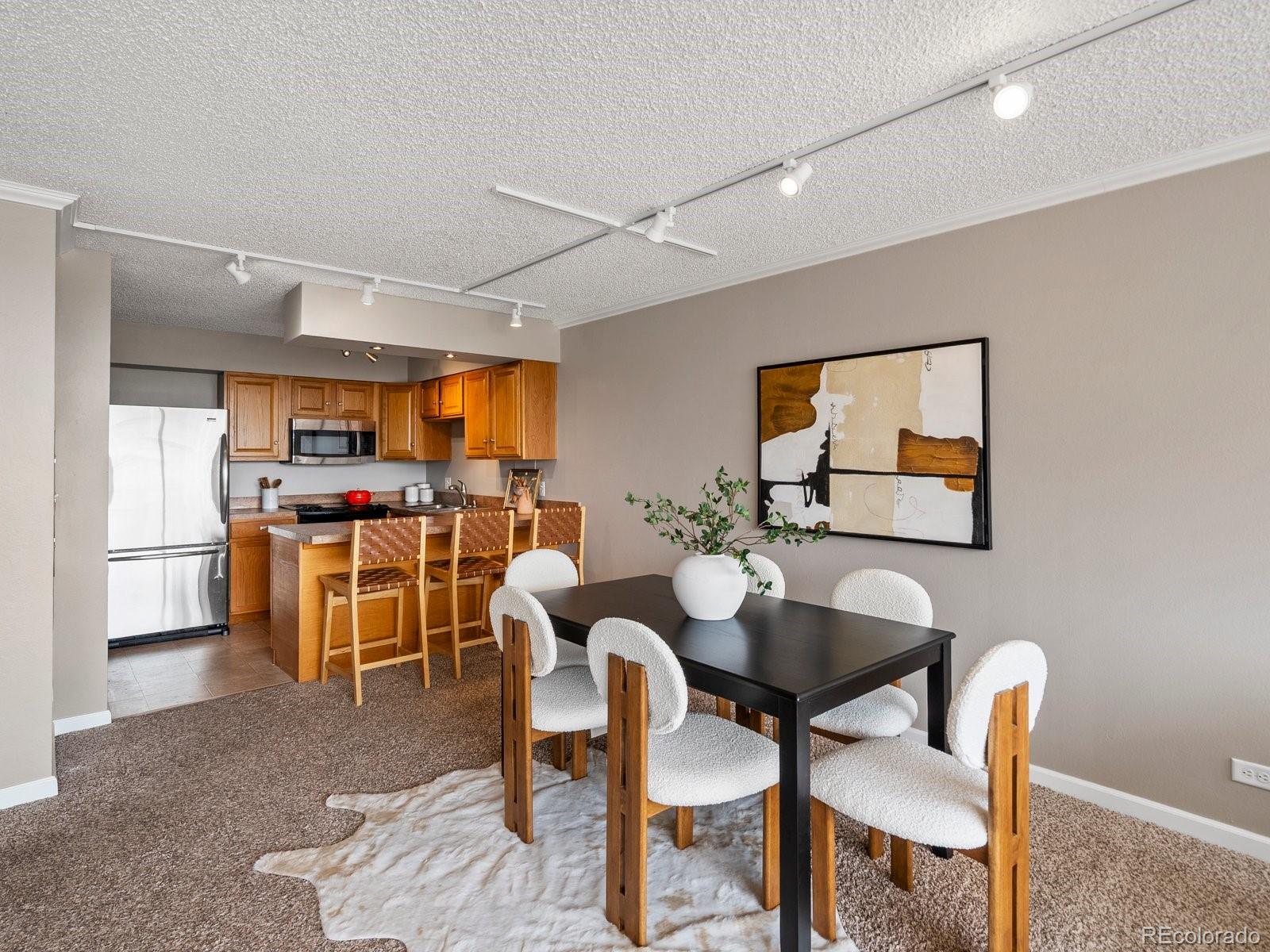 1850 Folsom Street, Unit 402 Boulder, CO 80302 - Photo 20 of 28 a view of a dining room with furniture