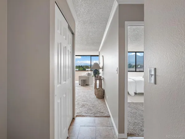 a view of a hallway with wooden floor and closet