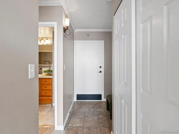 a bathroom with a granite countertop sink a toilet a mirror a bathtub and shower