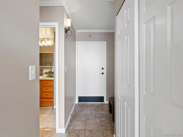 a bathroom with a granite countertop sink a toilet a mirror a bathtub and shower