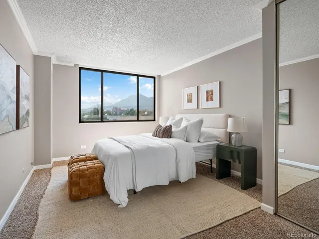 a bedroom with a large bed and a window