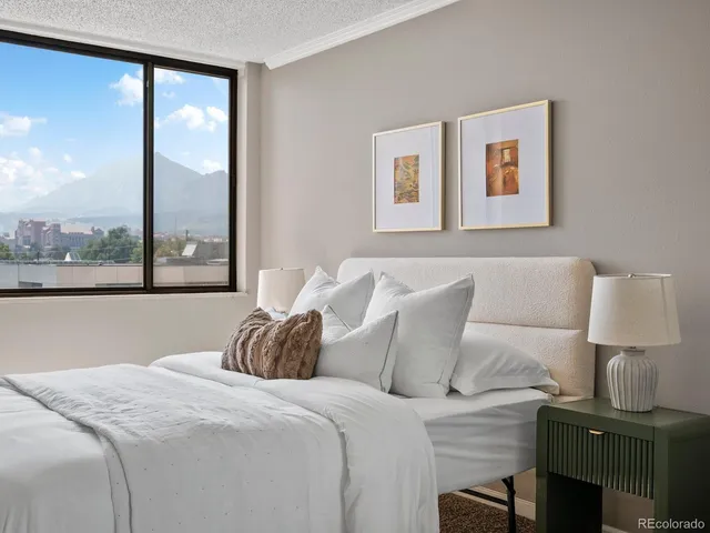 a bed sitting in a bedroom next to a window