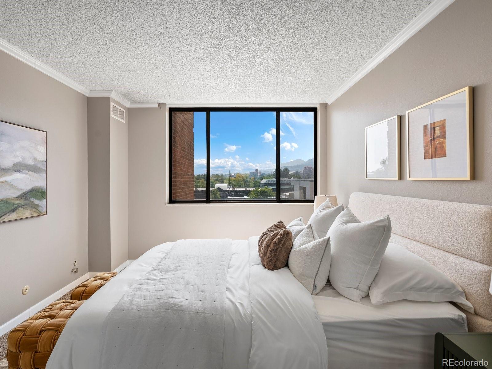 1850 Folsom Street, Unit 402 Boulder, CO 80302 - Photo 10 of 28 a bed sitting in a bedroom next to a window