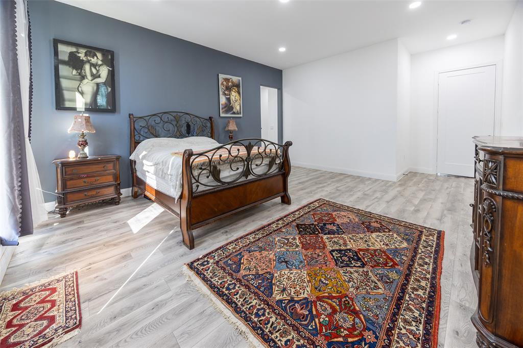 2630 Rockhill Road Aubrey, TX 76227 - Photo 25 of 36 a bedroom with a bed and a couch