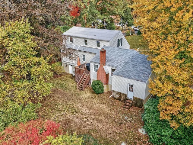 an aerial view of a house with a yard