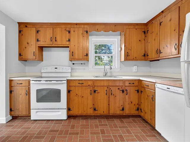 a kitchen with stainless steel appliances granite countertop a sink stove and cabinets