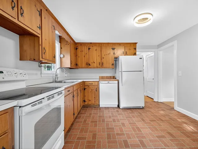 a kitchen with a refrigerator sink stove and cabinets