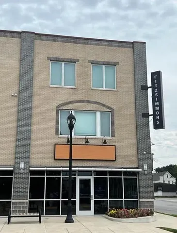 a front view of a house with a parking space